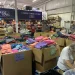 Kids to Love volunteers pack thousands of backpacks for foster care drive