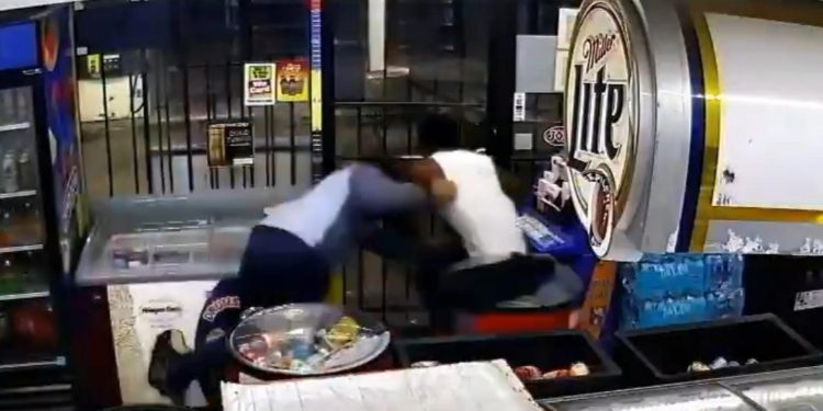 Video show store clerk fighting back against armed robbery suspect near downtown Houston