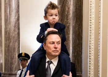 Elon Musk's four-year-old son looks like his mini-me twin as he arrives at Capitol Hill on his dad's shoulders
